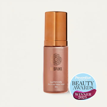 Beauty serum bottle with bronze cap and body, featuring Bespoke brand and Prevention Beauty Awards winner badge on a white background.